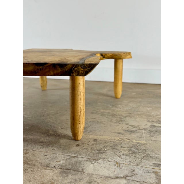 Handcrafted natural edge coffee table featuring an exceptional solid wood slab with striking, organic grain. The free-form...