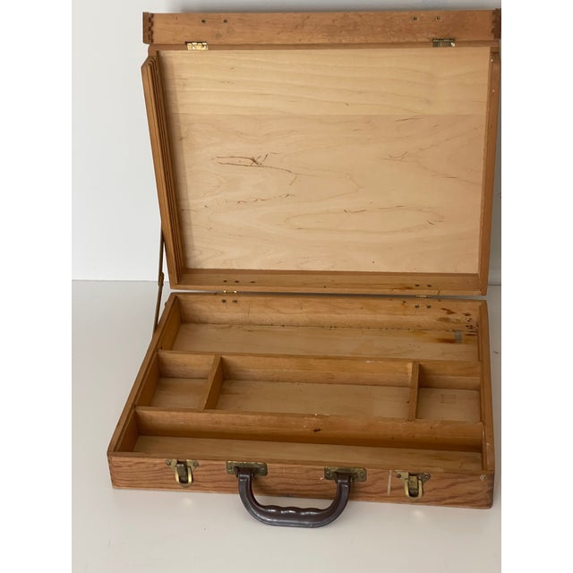 Vintage artist painters box for art supplies or outdoors painting. Compartments for paints, brushes and painters pallets.