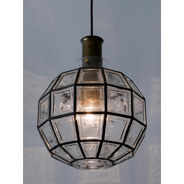 Elegant and highly decorative mid-century modern pendant lamp or hanging light. Designed & manufactured by glashütte...