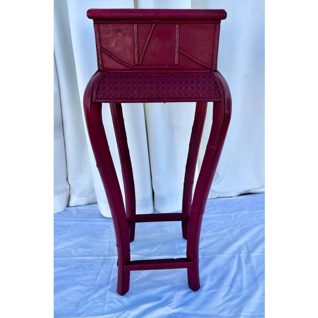 Let us present to you this beautiful Vintage Newly Painted Ruby Red Split Bamboo and Rattan Caning Plant Stand! This...