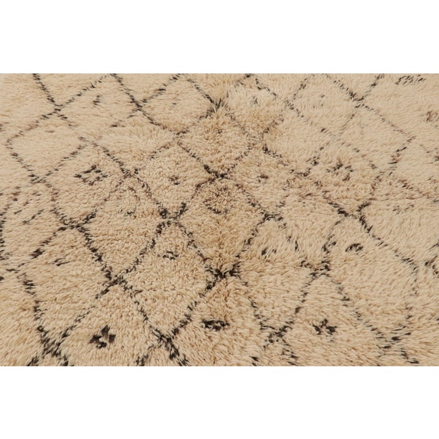 Hand-knotted in wool and originating from Morocco circa 1950-1960, this 7x7 vintage square rug is among the most exciting...