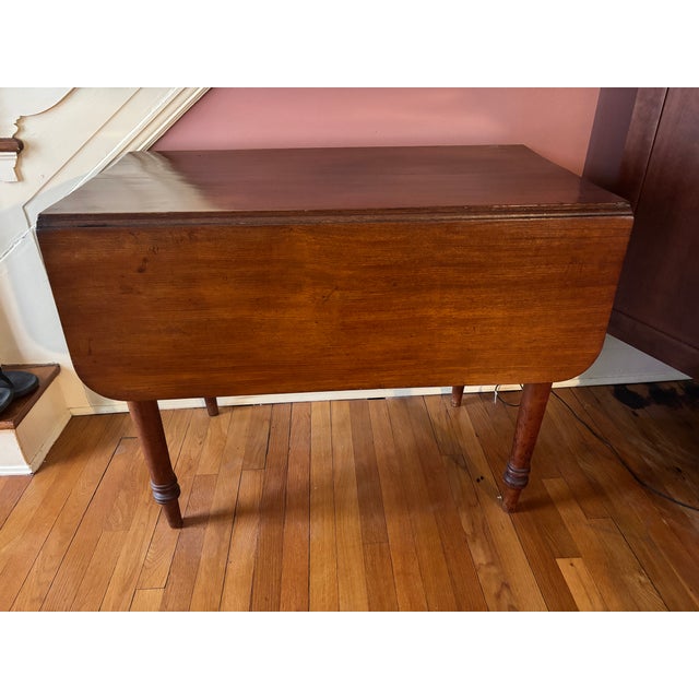 Antique 19th Century Solid Wood Drop Leaf Table. A classic accent table featuring beautifully turned legs, double drop...