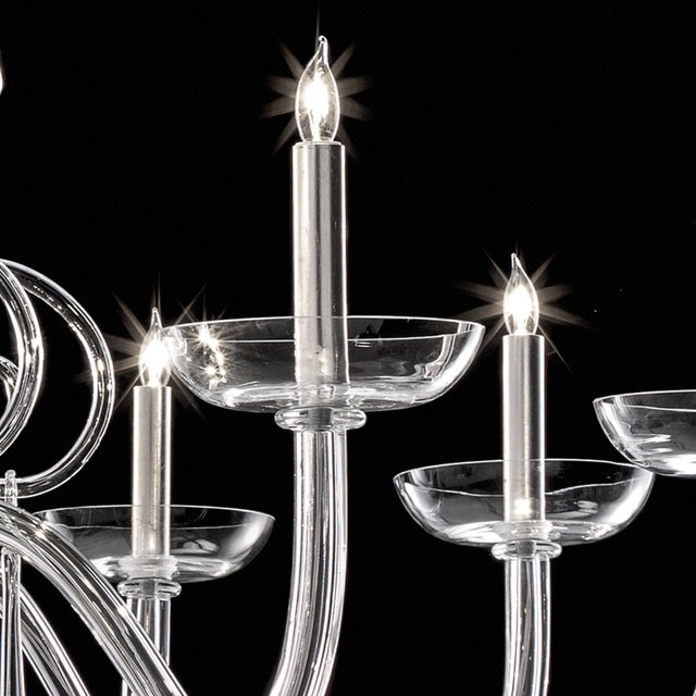 Elegant and sinuous chandelier in trasparent blowing Murano glass and chromed metal frame. Shenographic italian chandelier...