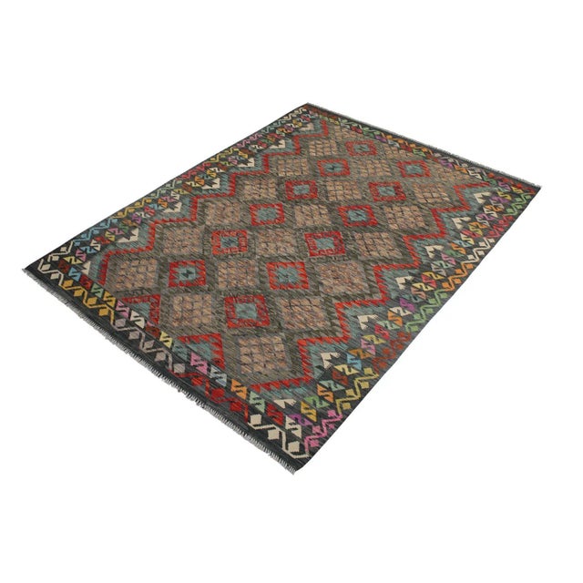 "Add a touch of elegance to your home with this casual chic hand woven Tribal Kilim wool rug. Constructed on a loom by...