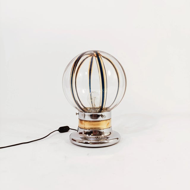Italian table or table lamp by Toni Zuccheri, 1970s. Body formed by a metal base in gold and silver chrome, where the lamp...
