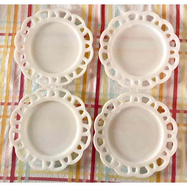 Grace your table with this charming set of four vintage white milk glass luncheon plates, attributed to Hazel-Atlas....