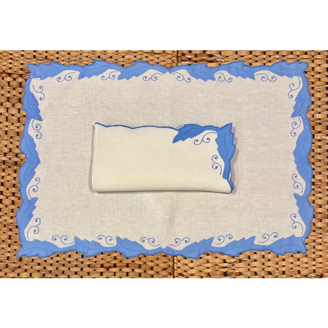 Service for 4 in crisp white linen with an elegant cornflower blue appliqué leaf border and coordinating swirl embroidery...