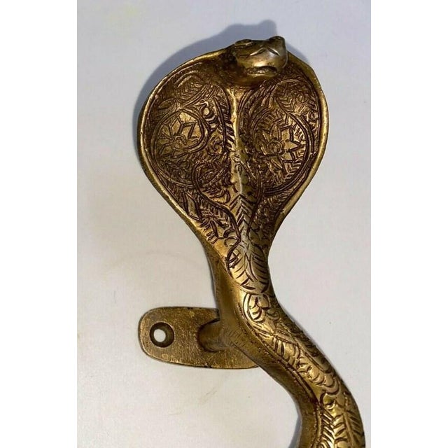 Add a bold, sculptural statement to cabinetry, doors, or furniture with this engraved brass cobra snake handle by Indian...