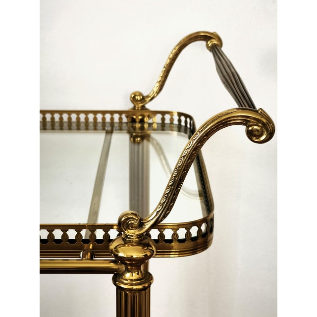 Vintage brass and glass bar cart, made between the 1950s and 1970s in the Hollywood Regency style. Solid brass frame with...