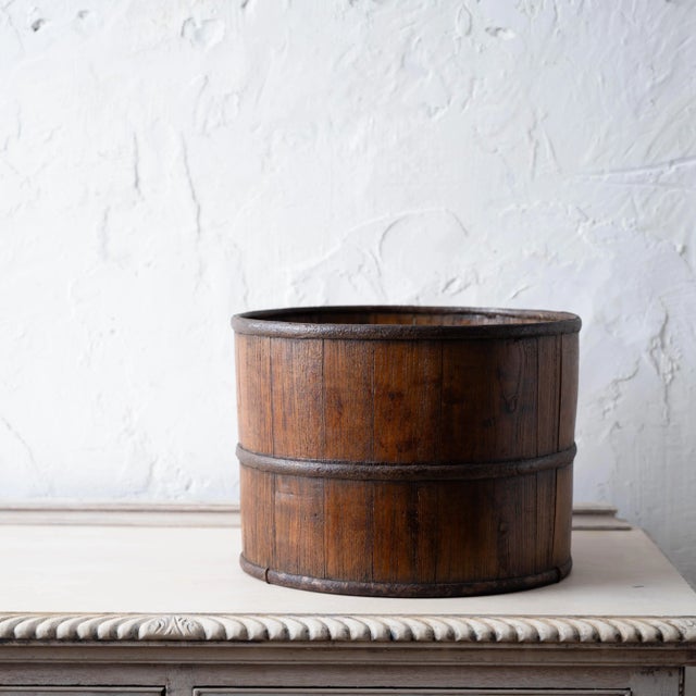 An asian iron and wood coopered bucket, 19th century. 12 ½ inches iwde by 9 ¼ inches tall