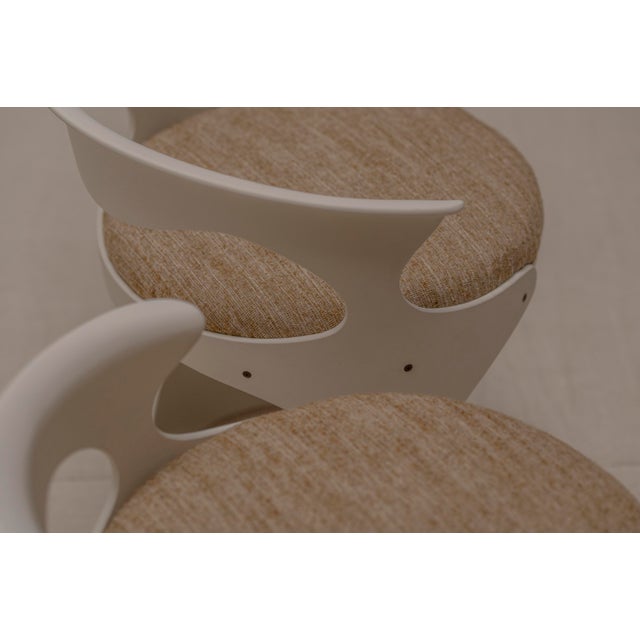 A striking and sculptural Space Age dining chair set, defined by its flowing curves and soft architectural lines,...