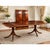 Traditional mahogany dining table with scalloped corners. Duncan Phyfe–style double-pedestal dining table with three...