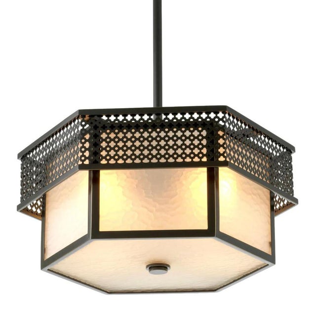 Ceiling lamp in metal with a bronze finish and frosted glass. This model features a hexagonal structure composed of tiered...