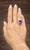 An approximately 16.0-carat amethyst takes center stage, displaying a rich purple hue in an oval cut. Surrounding the...