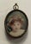 Antique portrait miniature of a child with flowers in her hair. Unsigned and mounted in a metal case to display or wear as...