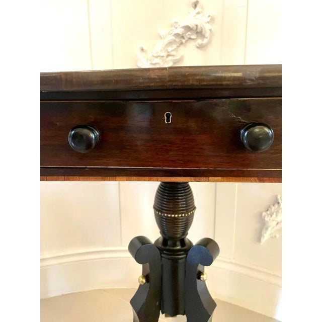 Antique regency rosewood lamp table having a quality rosewood top with satinwood inlay, one drawer and one dummy draw to...