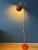 Mid-century orange "space age" floor lamp featuring a striking eyeball shade-an iconic design that perfectly captures the...