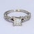 This classy 14k white gold ring features a large princess cut diamond center, and has a twisted band mimicking vines, with...