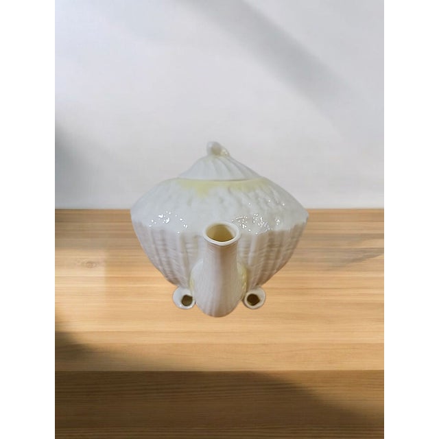 This exquisite vintage teapot from the renowned Belleek Pottery in County Fermanagh, Northern Ireland, is a charming...