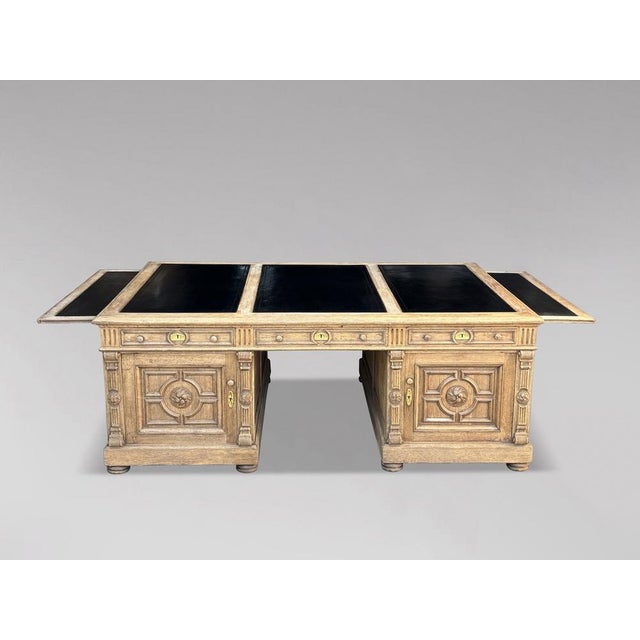 This stunning mid-19th-century French oak partners desk is a masterpiece of design and functionality, featuring a newly...