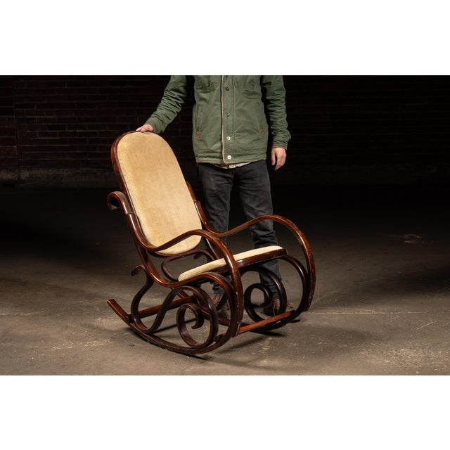 Gracefully proportioned bentwood rocking chair executed in the Thonet style, featuring continuous steam-bent curves...