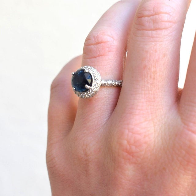 This double halo ring (circa 2000) is masterfully crafted in solid 18k gold. At the heart of this masterpiece sits a...