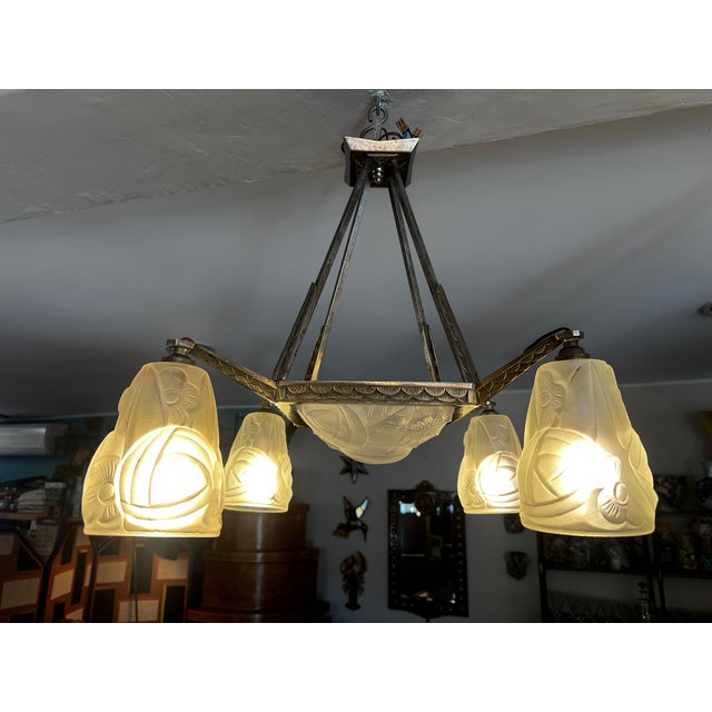 Elegant Art Deco chandelier dating from the 1930s, crafted from silvered bronze and molded opaline glass. This superb...