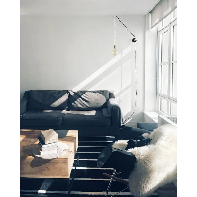 This handmade minimalist wall lamp is made of steel tubes and brass elements. The steel is oxidized and preserved. The arm...