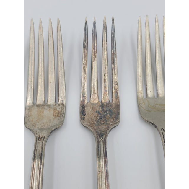 This set of five silverplate dinner forks features the striking Lady Betty pattern from International Silver Co. Unlike...