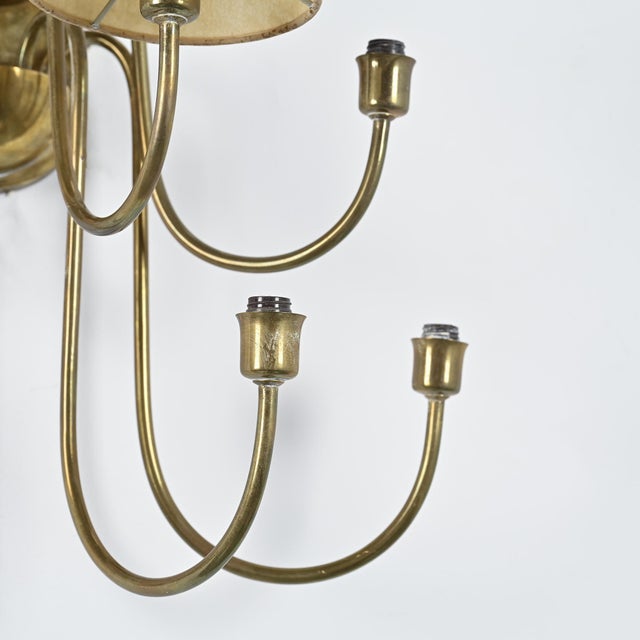 Bouquet nine-arm wall sconce, made in France around 1960. The brass structure consists of radiating, curved arms arranged...