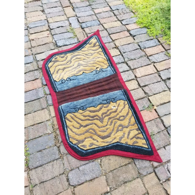 This unusually-shaped textile is known as a "makden" and was originally used by a nomadic traveler as an artful covering...