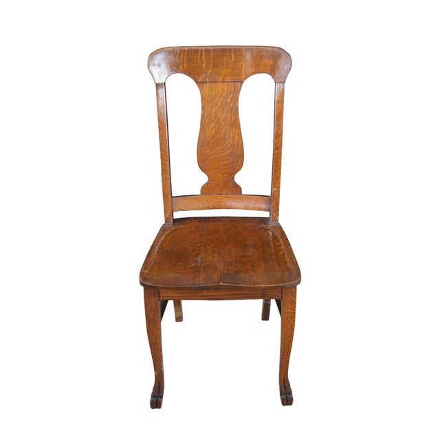 Early 20th Arts & Crafts Desk Chair. Features a quartersawn oak frame with vase shaped back and saddle seat. The chair is...