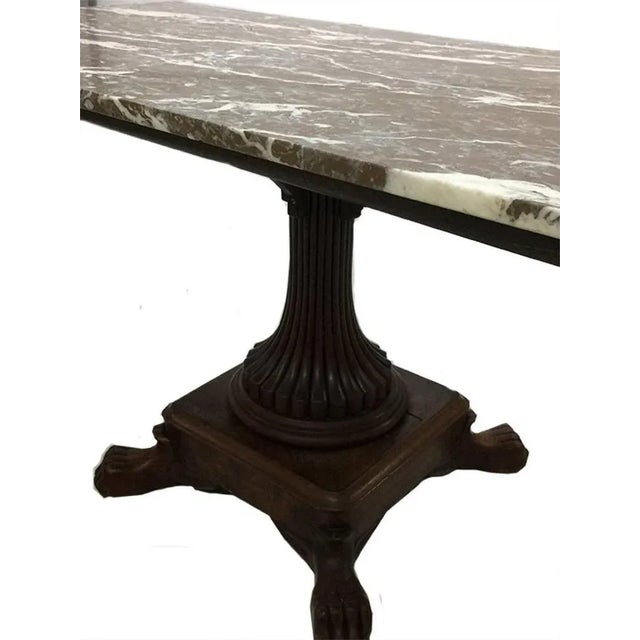 Mahogany table with marble top The mahogany table leg is from circa 1880 The table with lion feet and brown, grey and...