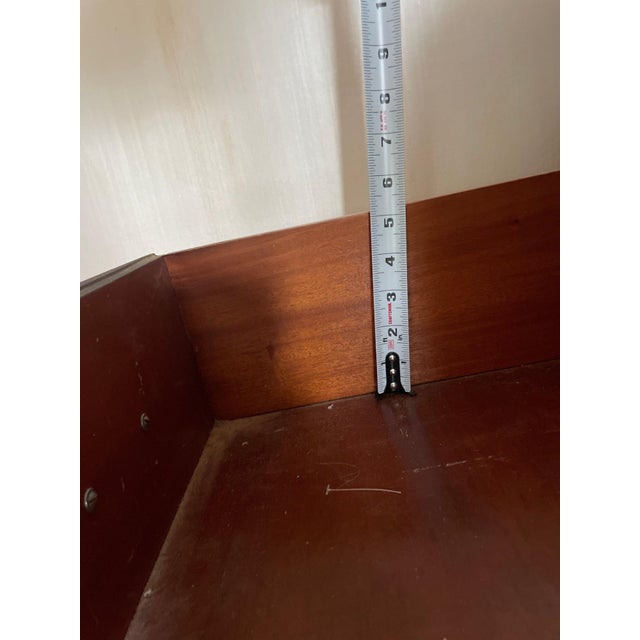 A beautifully crafted mahogany serpentine-front chest of drawers by Continental Furniture Company, showcasing the graceful...