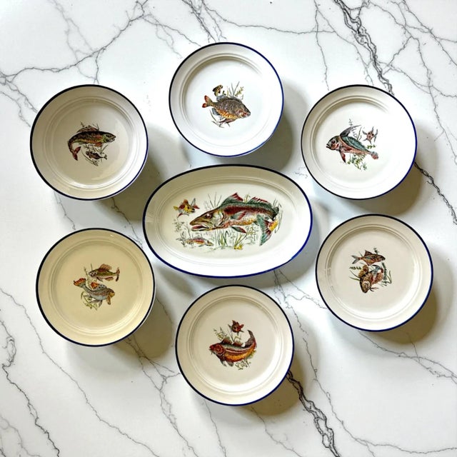 A rare complete mid-century Italian fish service from Deruta, Italy, featuring ten dinner plates and a large serving...