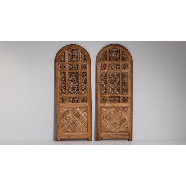 This early 20th century Egyptian Revival door from Egypt is finished in brown, worked in wood. Its design carries the...