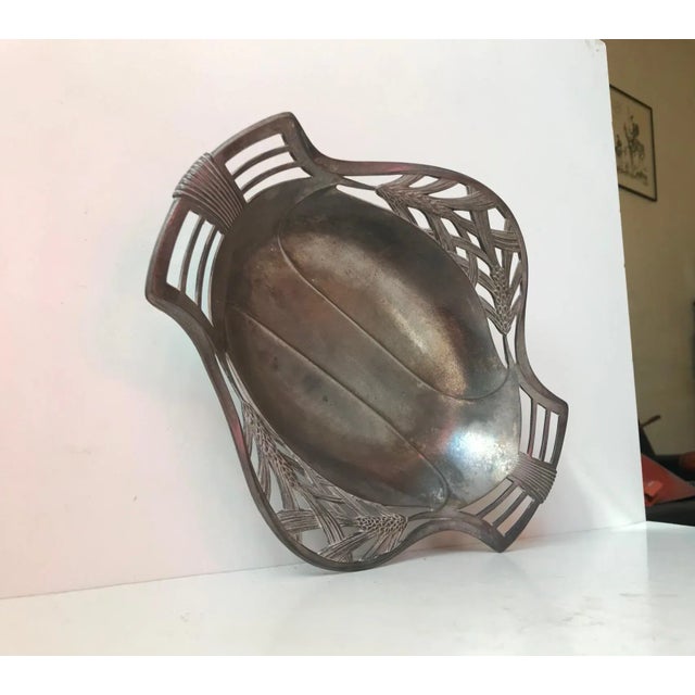 - A decorative fruit basket or tray - Made of partially perforated pewter - With intricate details and fine period...