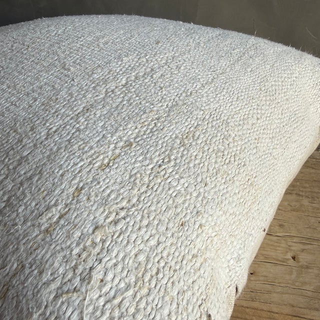 Creamy white hemp rug pillow with original seams. Soft hand, linen blend backing with zipper closure. Spot cleaning is...