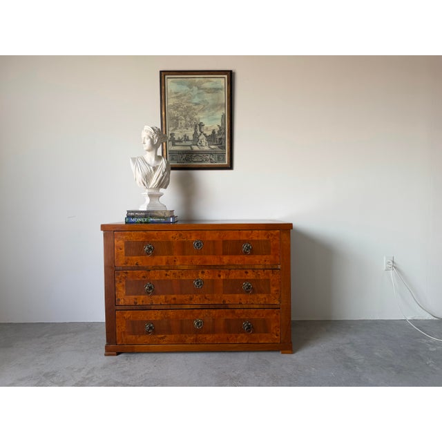 Elegant 19th-century German Biedermeier-style chest of drawers crafted with striking burr elm and flamed elm veneers over...
