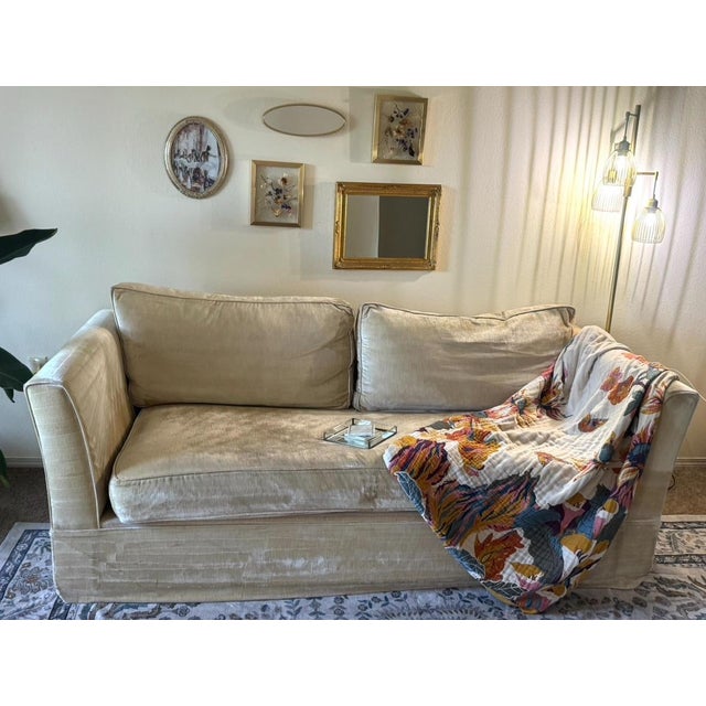 The upholstery is a custom designer velvet in a sophisticated Gold-Nude palette. It features a dense, heavy-weight pile...