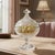 Elegant footed crystal lidded candy dish featuring a deeply pressed geometric pattern and faceted finial. Likely German or...