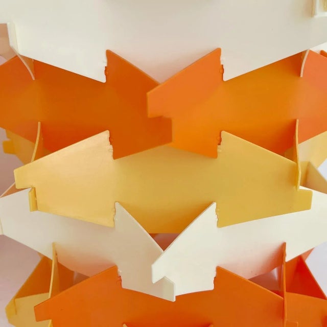 Fabulous and rare pair of 1960s Danish Modern pendant lights by Cosmo featuring layers of colorful plastic interlocking...