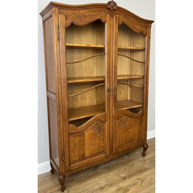 This elegant Vintage French Louis bookcase combines graceful styling with practical storage, featuring an attractive oak...