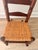 A charming vintage child’s rocking chair crafted from solid hardwood with a handwoven natural fiber seat. Features...