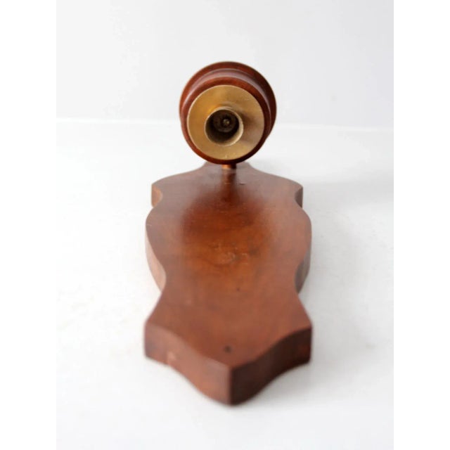 This vintage wooden wall candle holder features graceful lines and a warm, natural patina. The handcrafted sculpted wood...