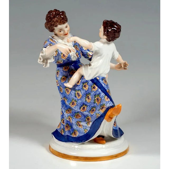 Very rare meissen art nouveau porcelain group: mother in a dress decorated with elaborate art nouveau decor sitting on a...