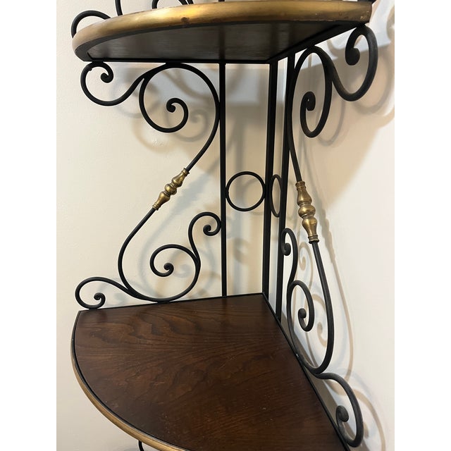 This is a mid 20th century wrought iron Bakers rack. This is a lovely, heavy corner baker's rack made of iron and wood...