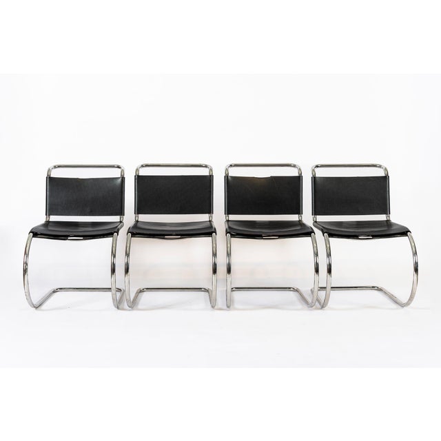 This set of four vintage Bauhaus Mies van der Rohe MR 10 black leather cantilever side chairs are manufactured by Knoll...