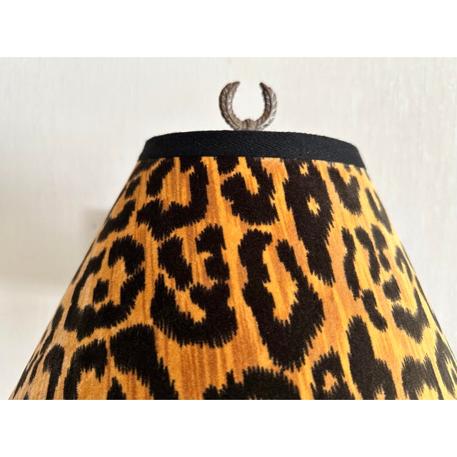 Vintage black metal lamp in classic urn shape with decorative side handles Accents on lamp are a rich antique gold color...