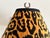 Vintage black metal lamp in classic urn shape with decorative side handles Accents on lamp are a rich antique gold color...
